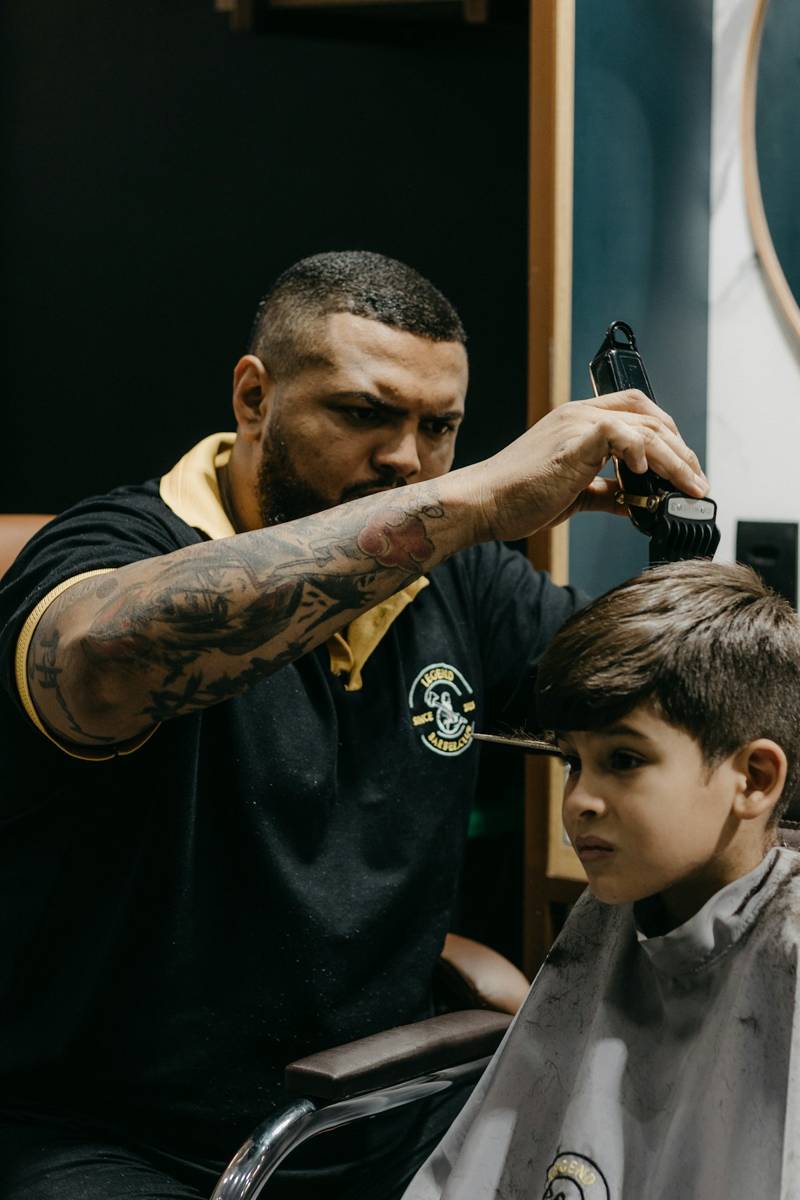 Barber cutting a young boy’s hair