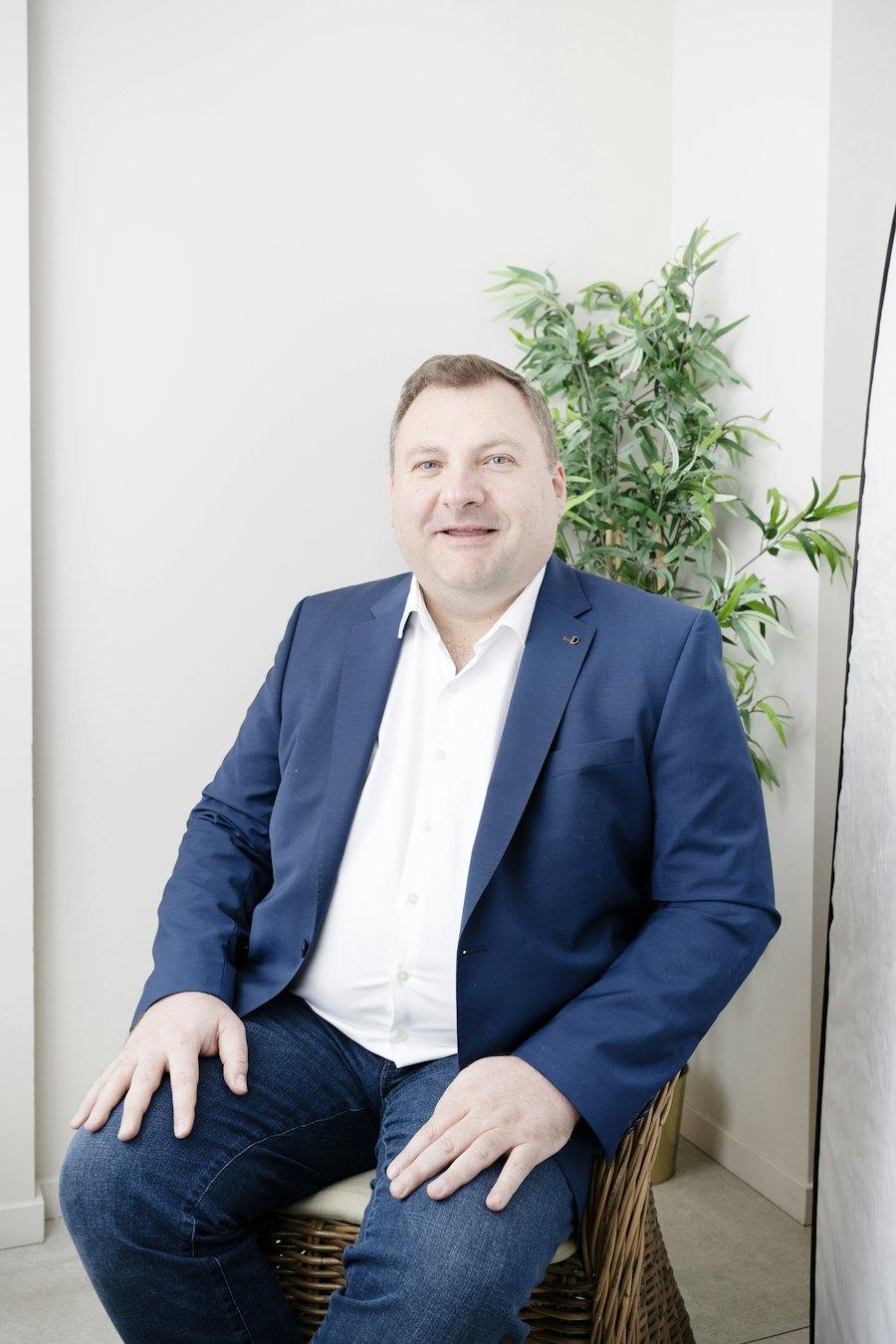 Portrait of Samuel Okafor, finance lead at Fieldnote Finance, seated beside a plant