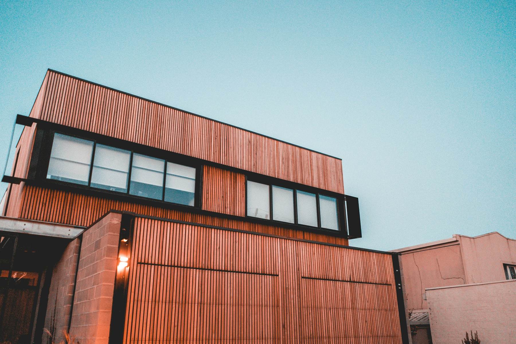 Modern home clad in vertical timber boards with black window frames