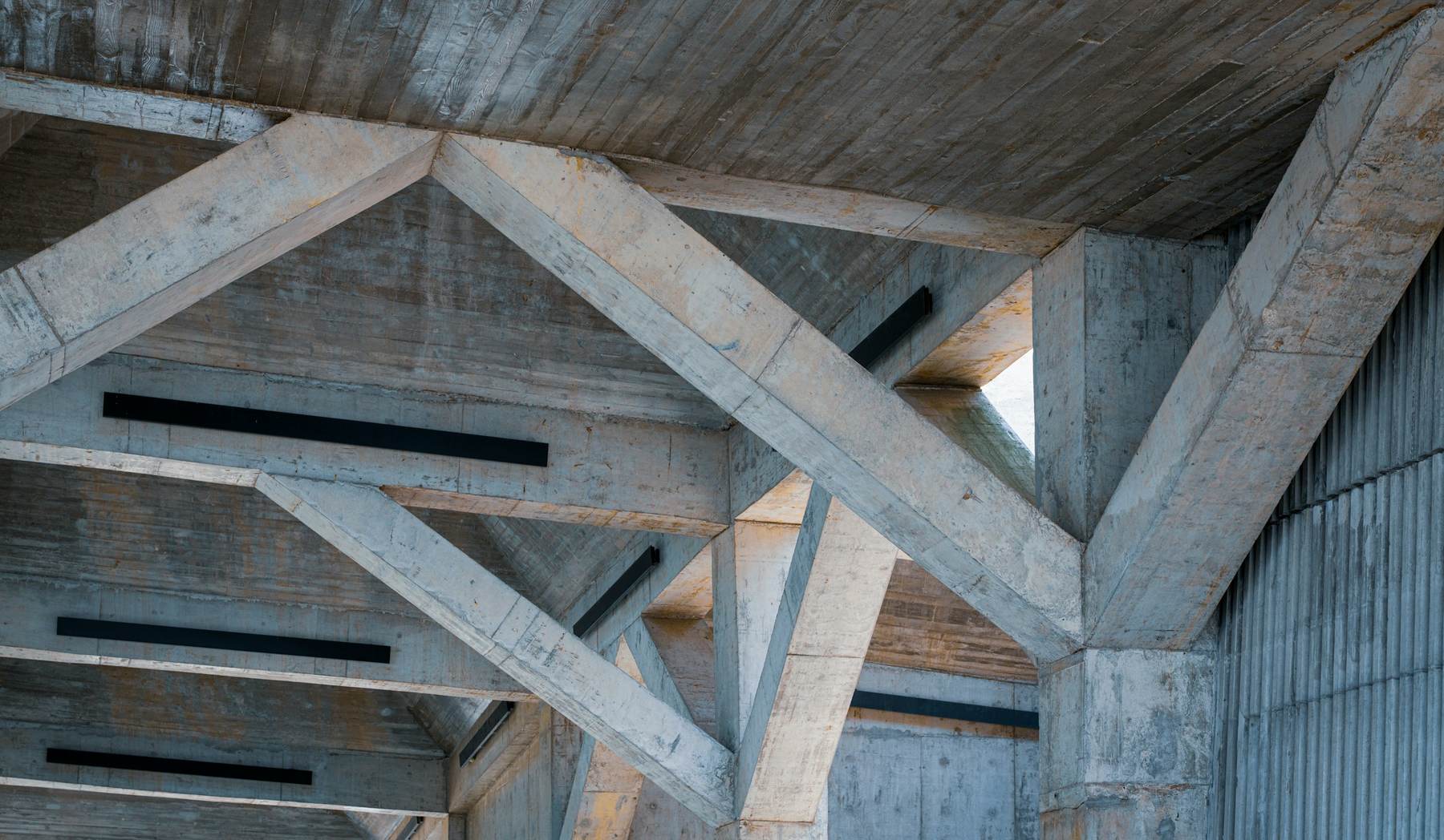 Exposed concrete beams crossing overhead