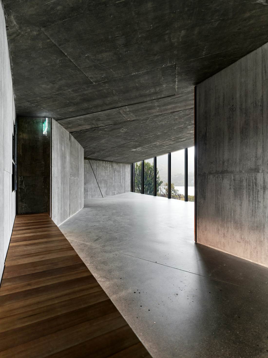 Concrete hallway with a warm timber floor
