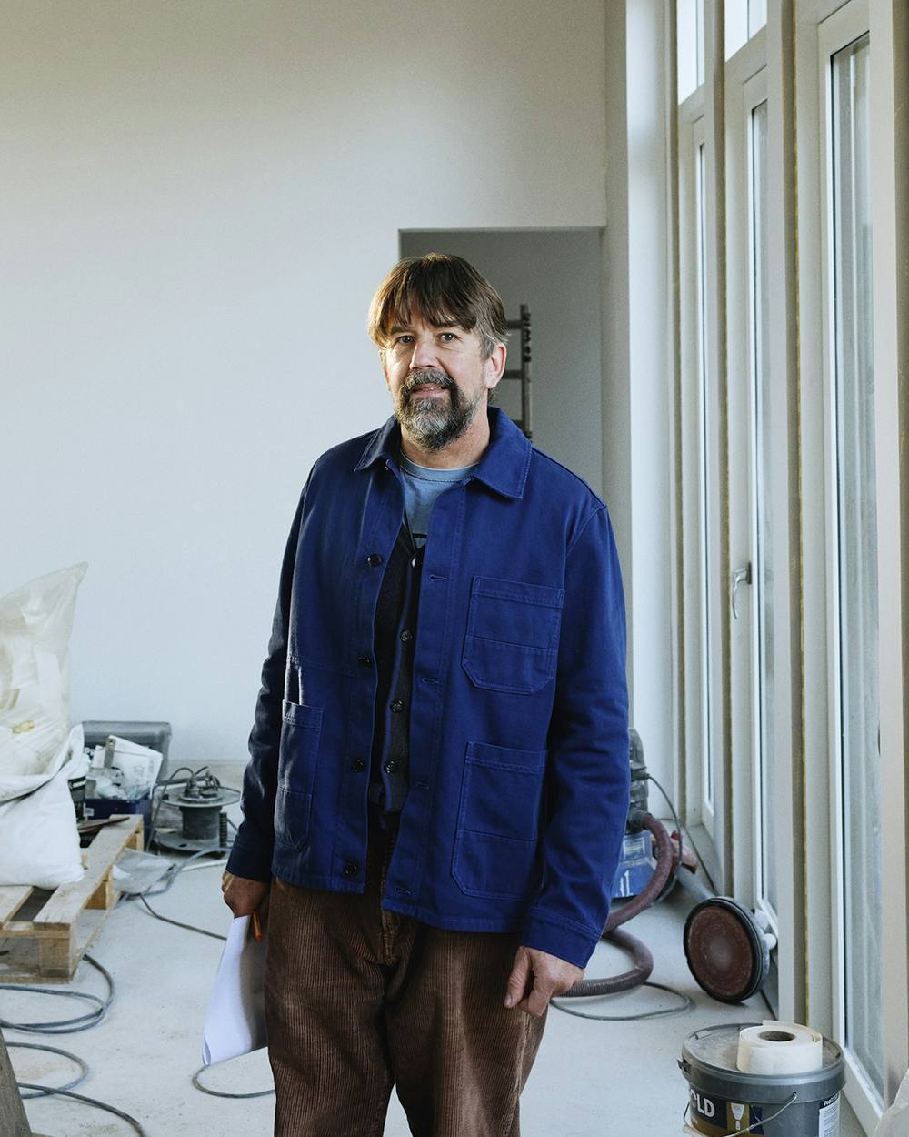 Owen Pryor, founder of Lintel and Field, standing in a home under construction