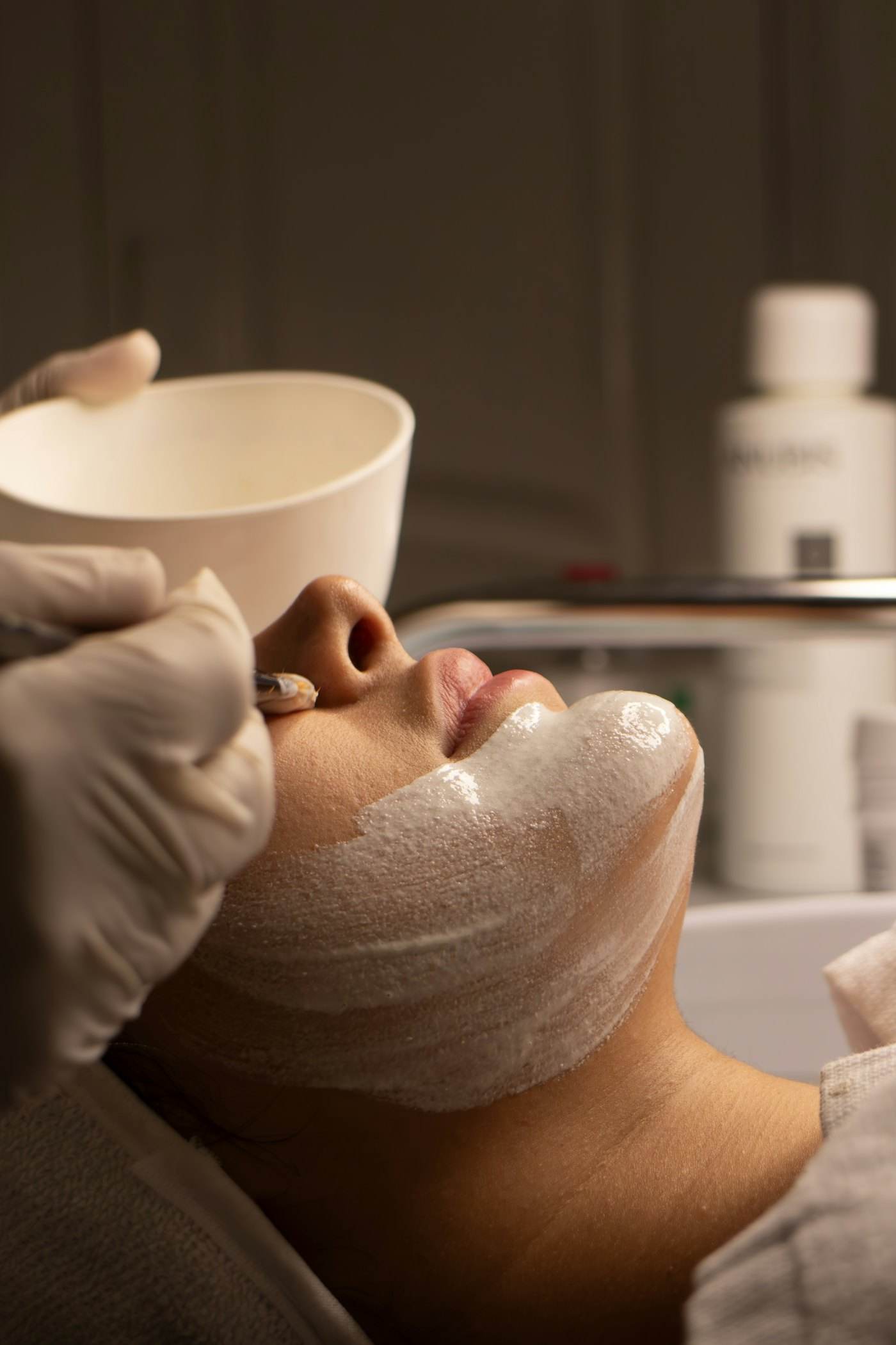 A person relaxing during a facial treatment