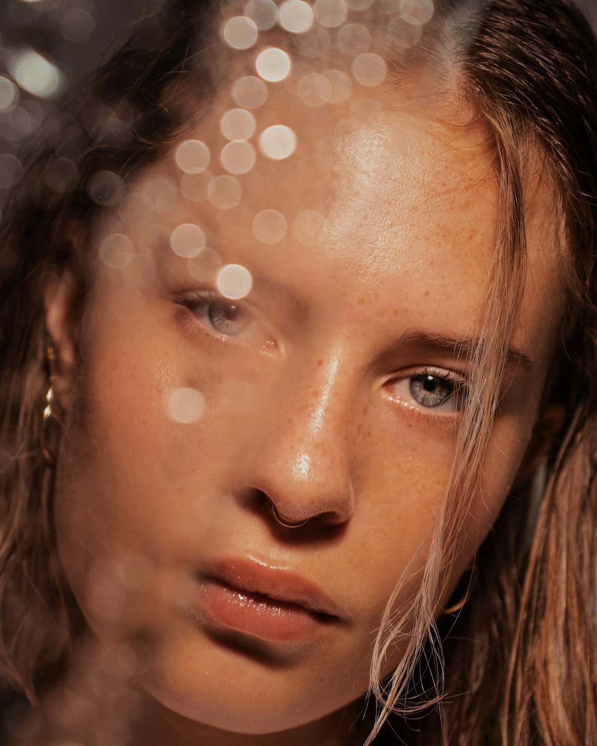 Close portrait of a woman with glowing skin and soft golden light