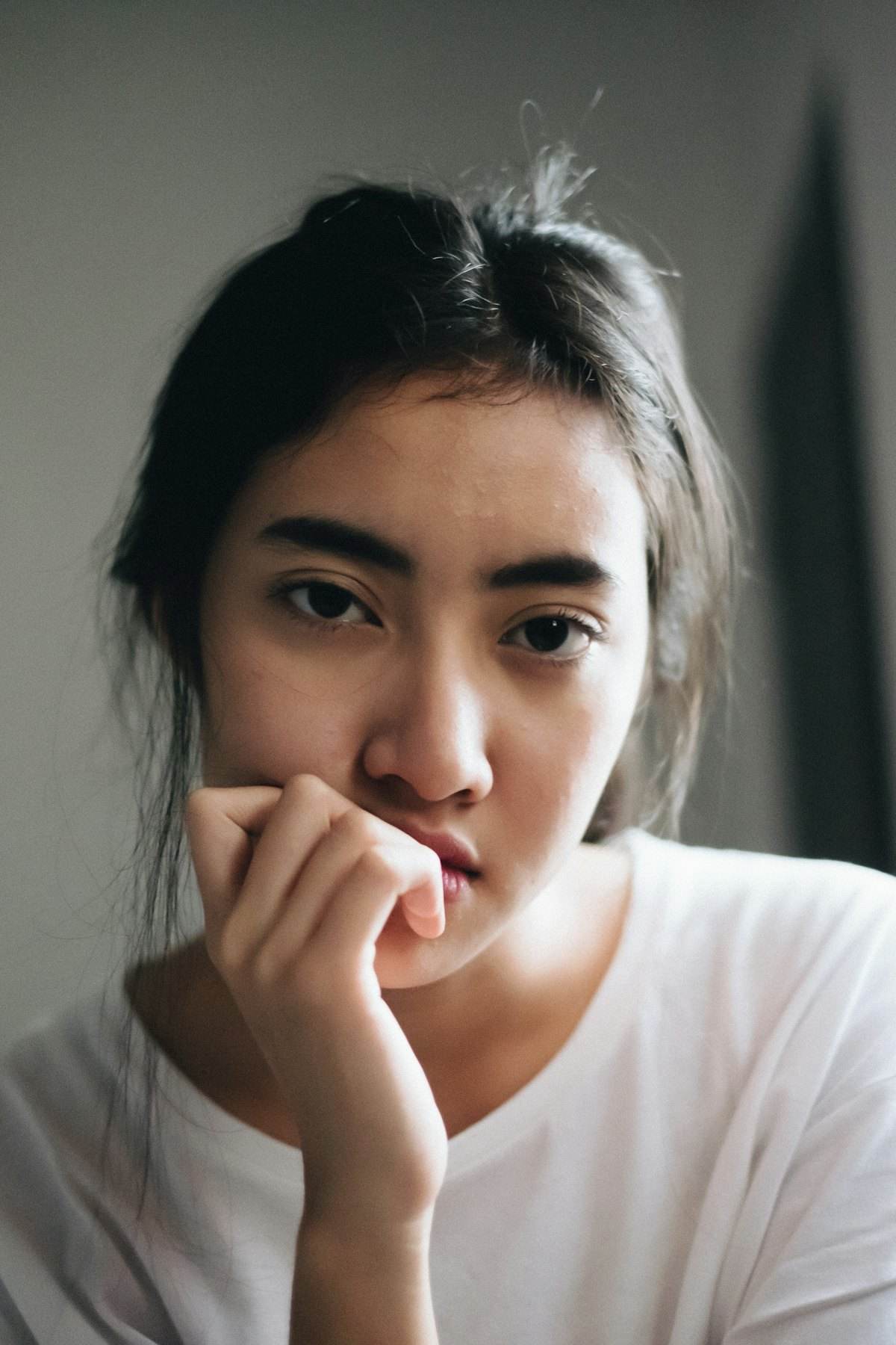 Portrait of a woman with long dark hair in a white top