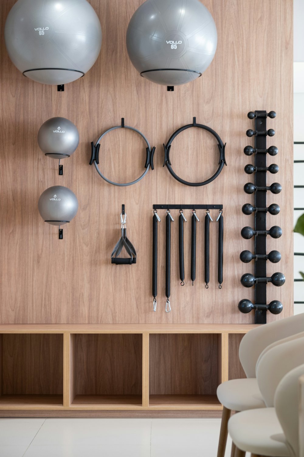 Pilates rings, balls and weights on a wooden wall