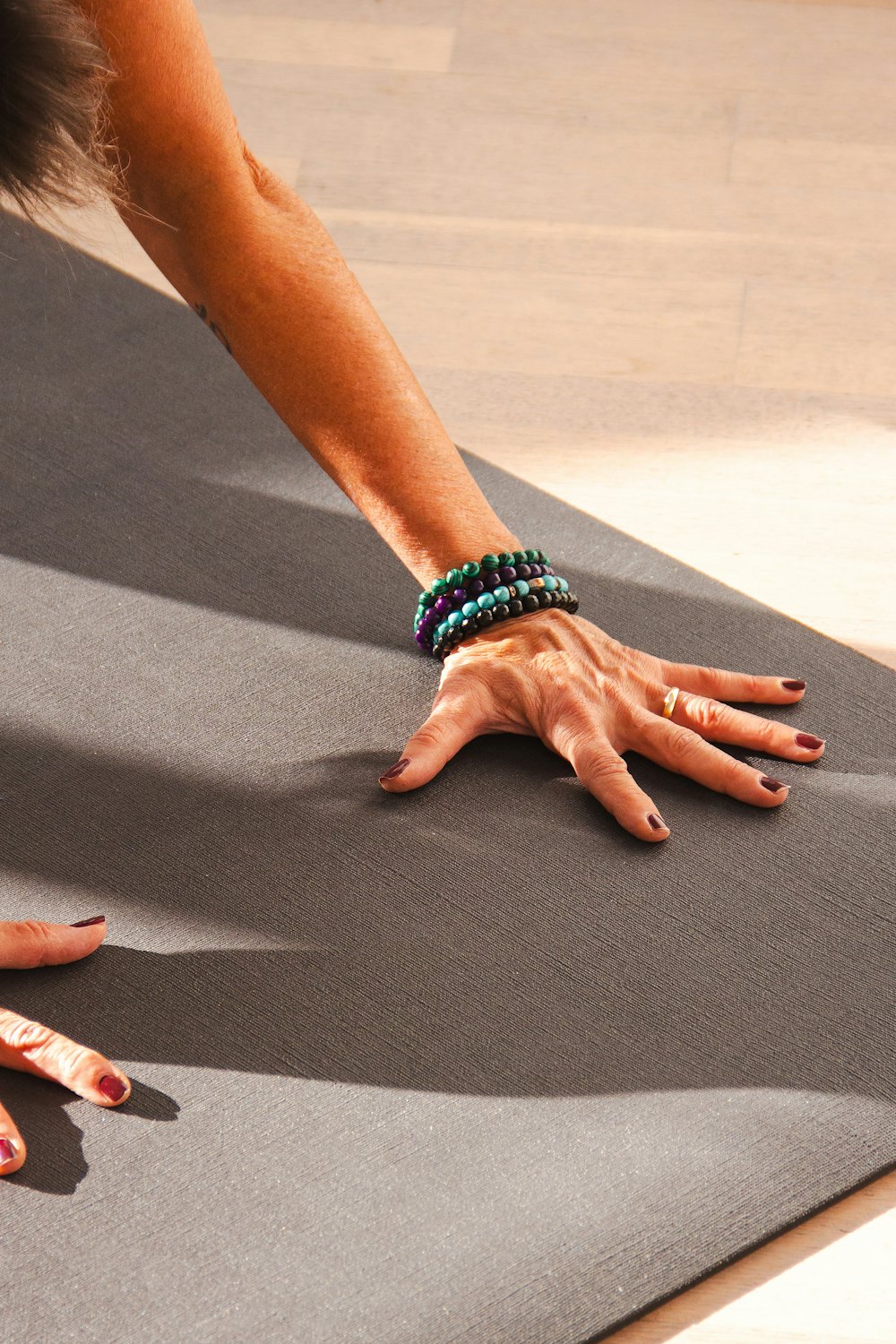 Hands pressing into a mat