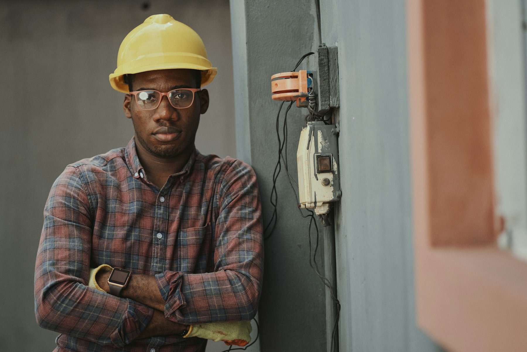 Crew member in a yellow hard hat and safety glasses