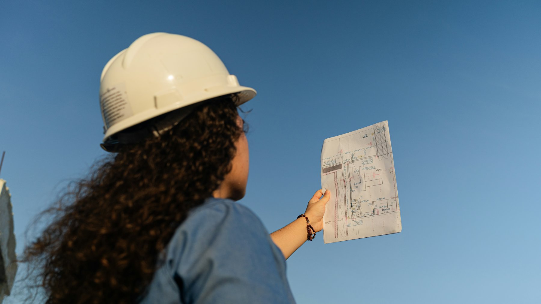 Estimator in a hard hat reviewing a report