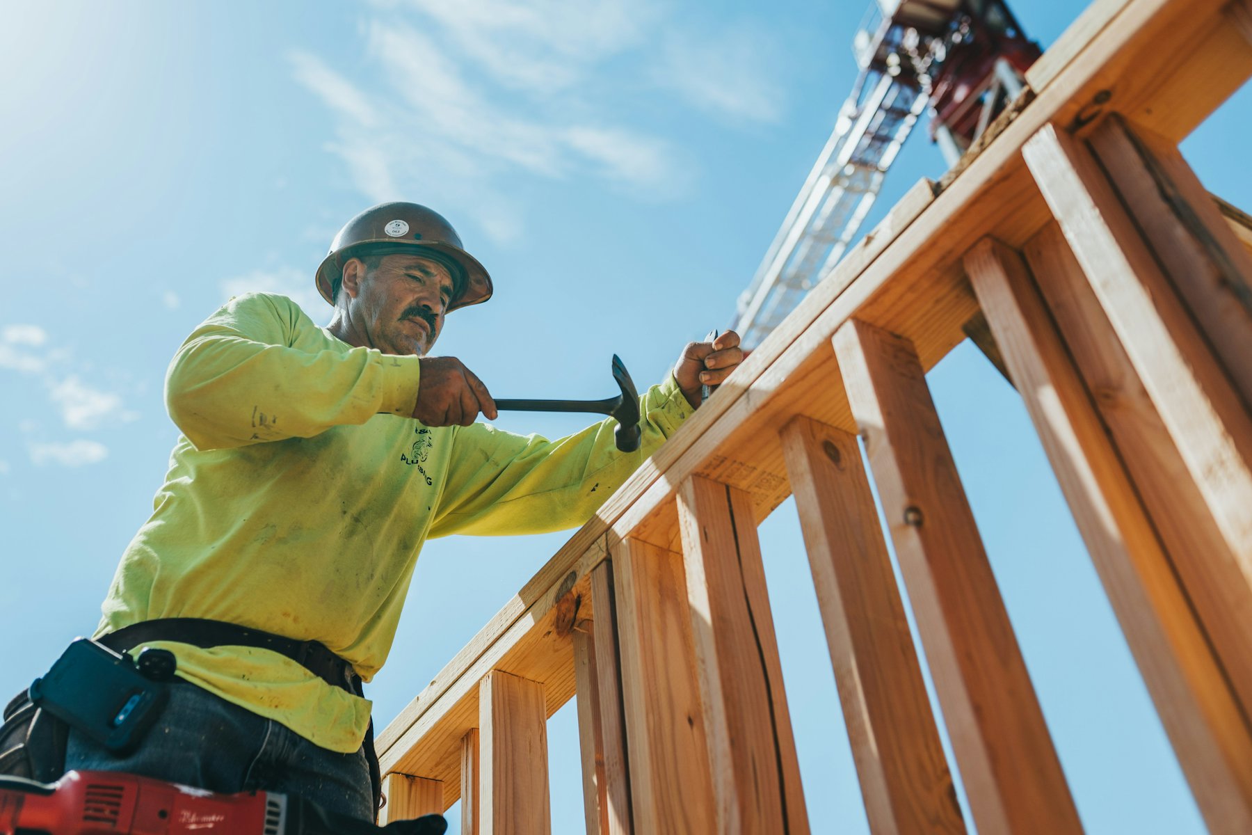 Crew member in a hard hat and safety gear at work