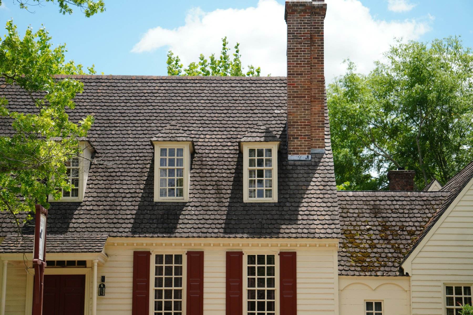 Colonial home with dormers and a brick chimney
