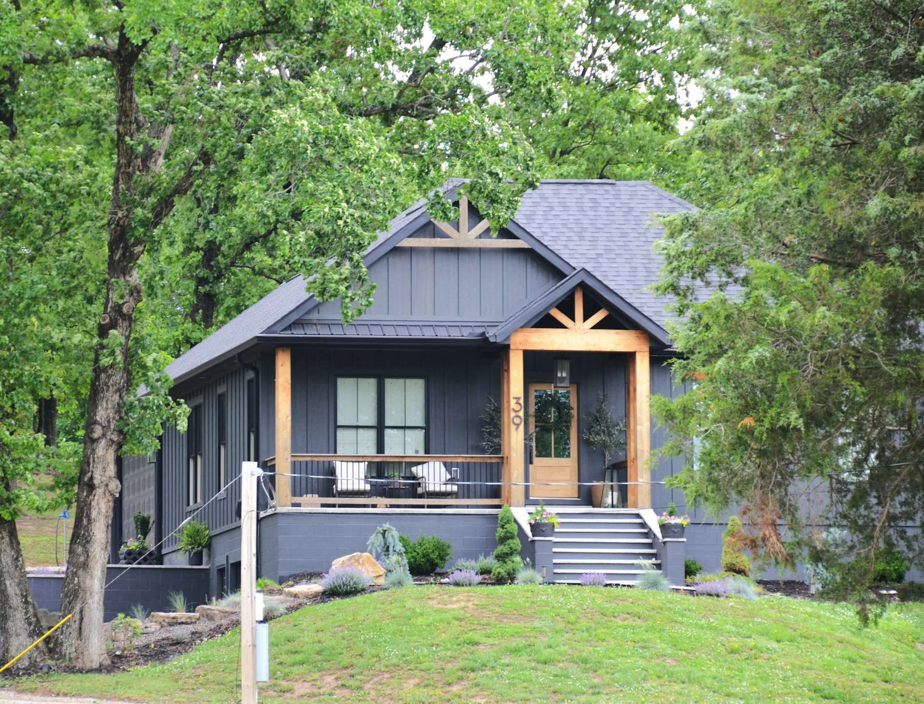 Dark gray craftsman home among trees