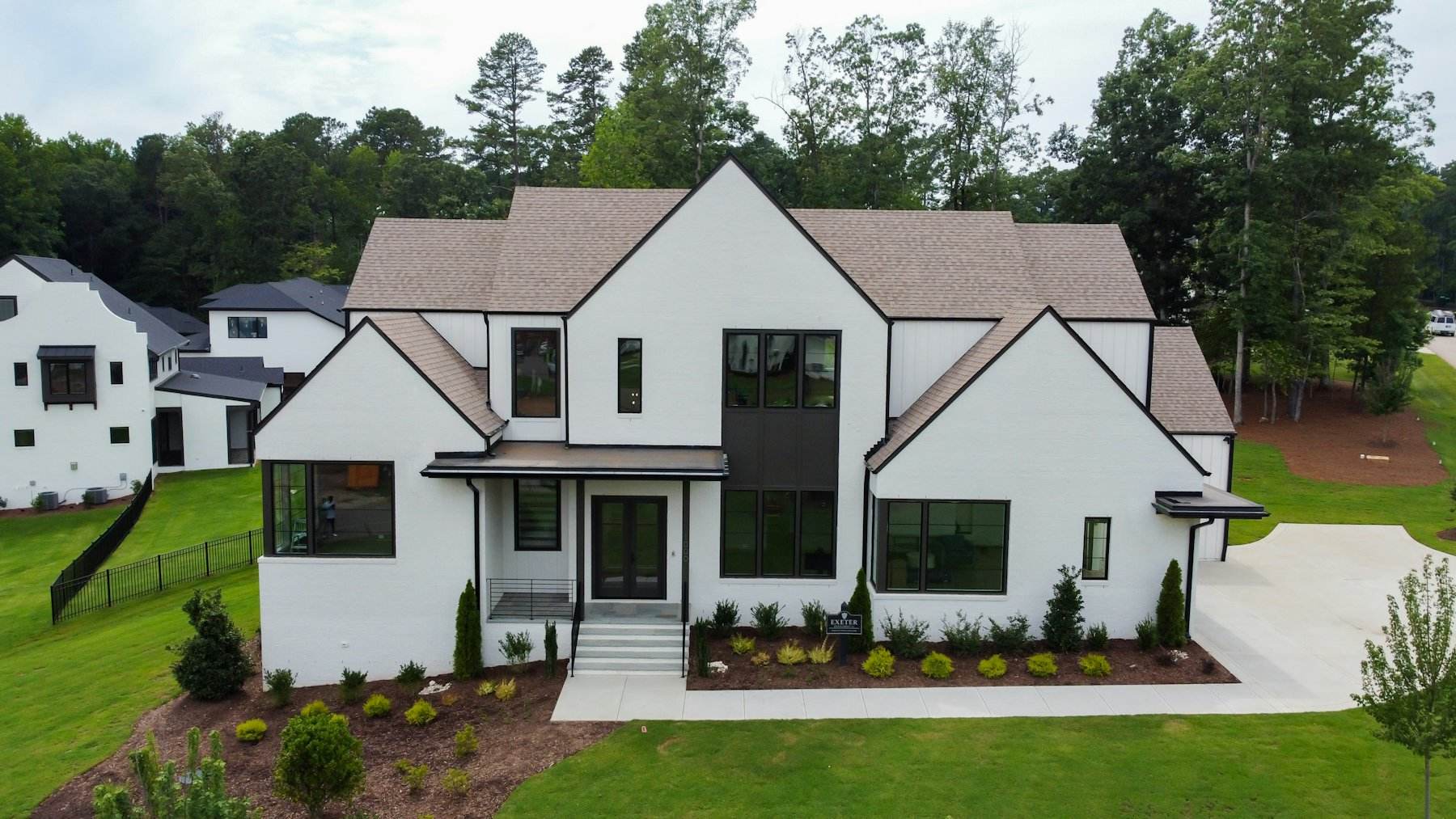 After: white farmhouse with a clean, new roof