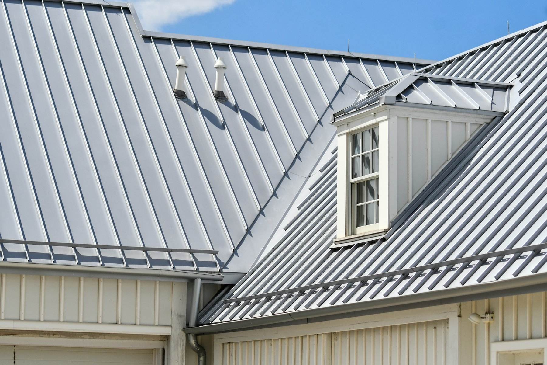 Grey standing seam metal roof with dormers