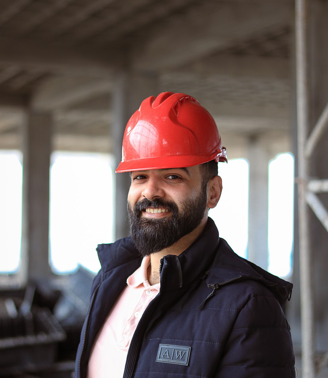 Sam Hadley, owner of Hardpitch Roofing, in a red hard hat